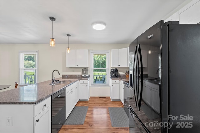 4916 Ritchie Rd, Lincolnton, NC 28092 - kitchen featuring dishwashing machine, freestanding refrigerator, a sink, a peninsula, and light wood finished floors