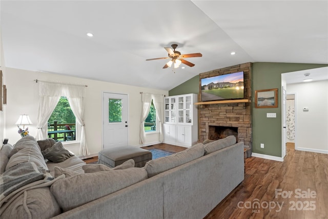 4916 Ritchie Rd, Lincolnton, NC 28092 - living room featuring lofted ceiling, ceiling fan, wood finished floors, a stone fireplace, and baseboards