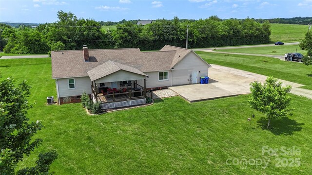 4916 Ritchie Rd, Lincolnton, NC 28092 - rear view of property featuring central AC unit, a patio, a yard, a chimney, and roof with shingles