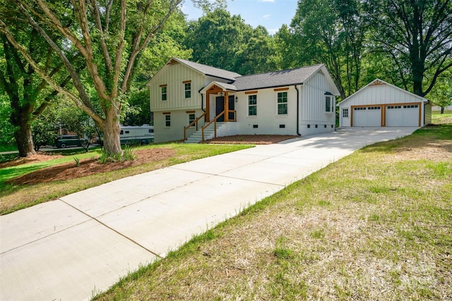 437 Chadmore S Dr, Charlotte, NC 28270 - split level home with an outbuilding, a garage, board and batten siding, roof with shingles, and a front yard