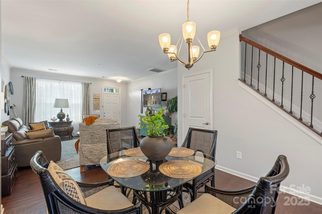 4313 Courtly Ln, Belmont, NC 28012 - dining space with a chandelier, wood finished floors, stairs, baseboards, and ornamental molding