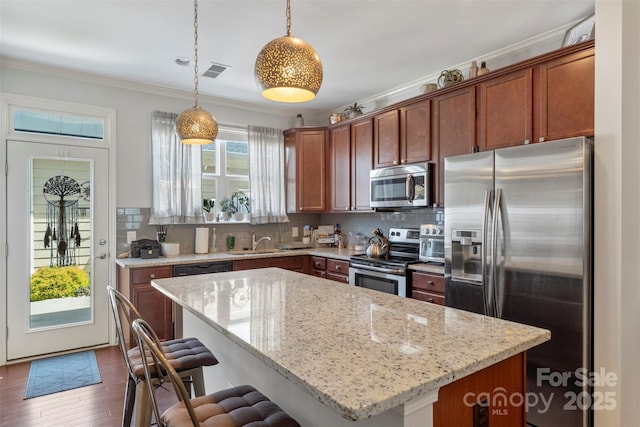 4313 Courtly Ln, Belmont, NC 28012 - kitchen featuring stainless steel appliances, a sink, light stone countertops, tasteful backsplash, and crown molding