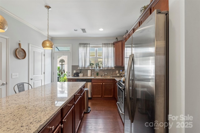 4313 Courtly Ln, Belmont, NC 28012 - kitchen featuring stainless steel appliances, a sink, light stone counters, dark wood-type flooring, and pendant lighting