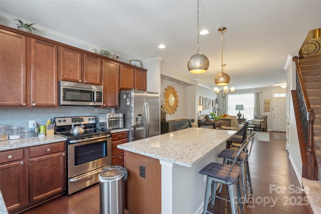 4313 Courtly Ln, Belmont, NC 28012 - kitchen featuring stainless steel appliances, open floor plan, a kitchen island, dark wood-style flooring, and recessed lighting