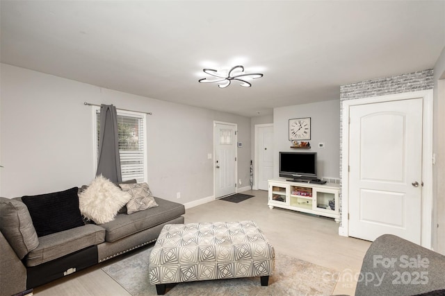living area featuring baseboards