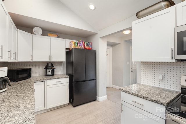 kitchen with black appliances, decorative backsplash, white cabinetry, lofted ceiling, and recessed lighting