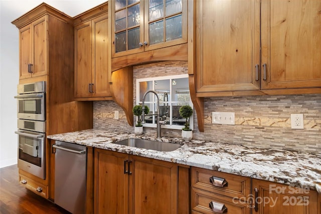 4001 Carmel Acres Dr, Charlotte, NC 28226 - kitchen featuring a sink, appliances with stainless steel finishes, brown cabinetry, and light stone countertops