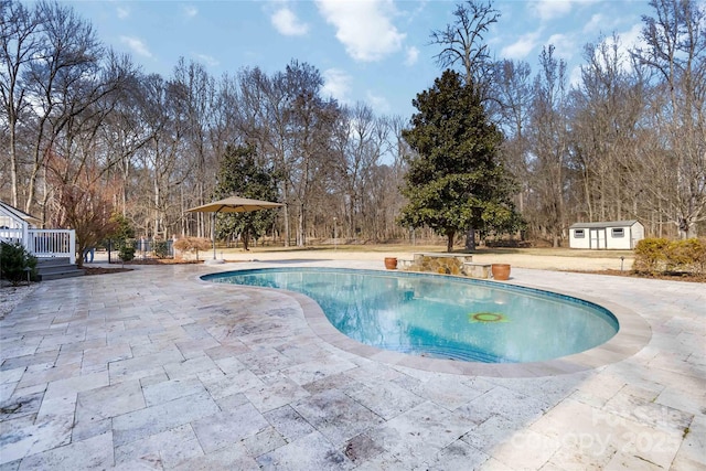 4001 Carmel Acres Dr, Charlotte, NC 28226 - swimming pool with a patio, an outbuilding, and view of wooded area