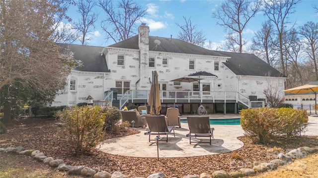 4001 Carmel Acres Dr, Charlotte, NC 28226 - back of property with stairway, a chimney, a deck, a patio, and an outdoor pool