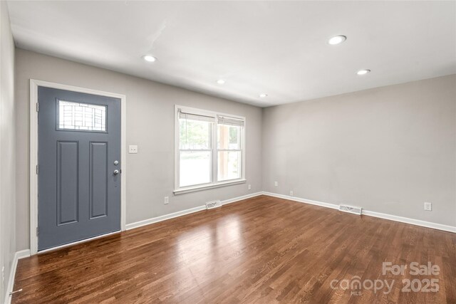 foyer entrance with wood finished floors, baseboards, and recessed lighting