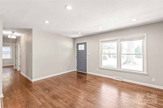 foyer featuring baseboards, plenty of natural light, and recessed lighting