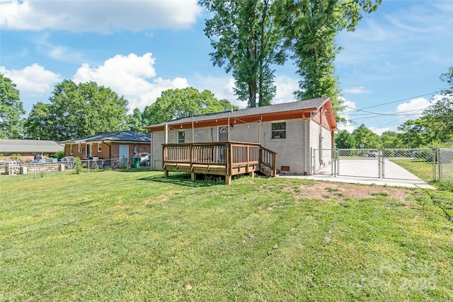 rear view of property featuring a deck, a gate, and brick siding