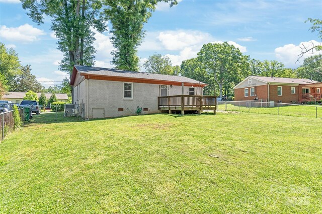 back of property with crawl space, a deck, and brick siding