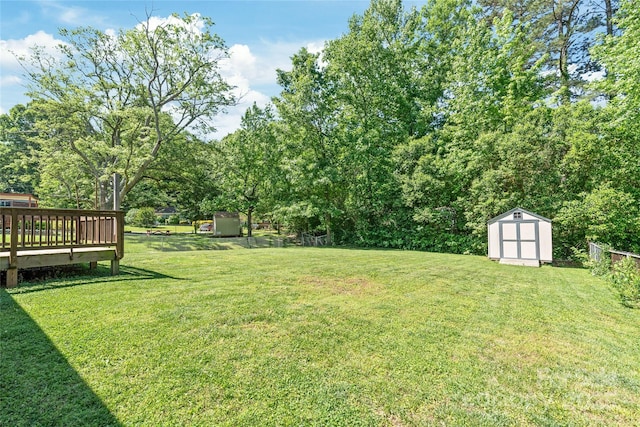 view of yard with a storage unit, an outdoor structure, and a deck
