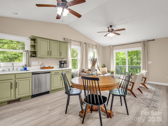 dining room featuring vaulted ceiling, ceiling fan, healthy amount of natural light, and light wood-type flooring