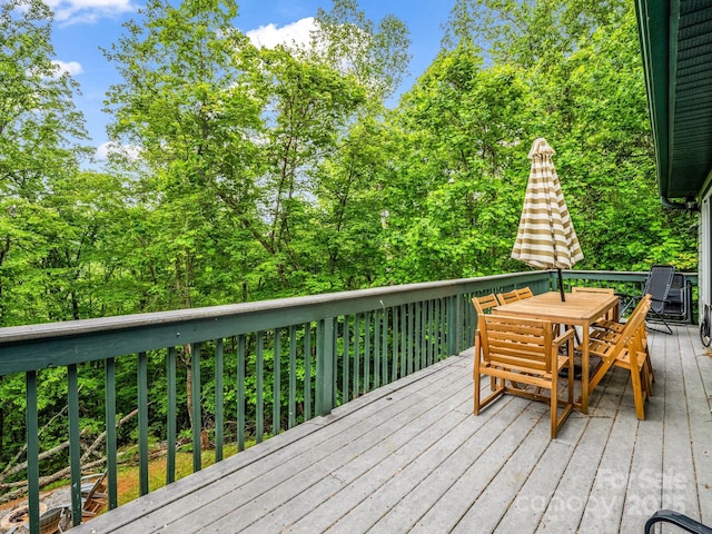wooden terrace with outdoor dining area
