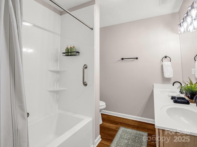 full bath with wood finished floors, toilet, baseboards, double vanity, and shower / bathtub combination