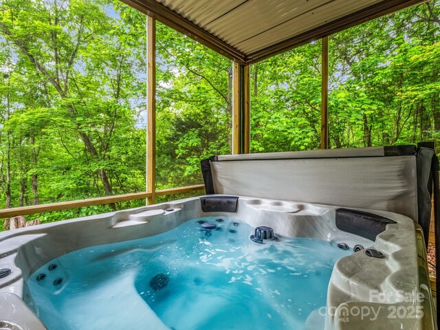 view of swimming pool featuring a hot tub