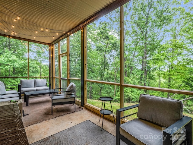 sunroom featuring an outdoor hangout area