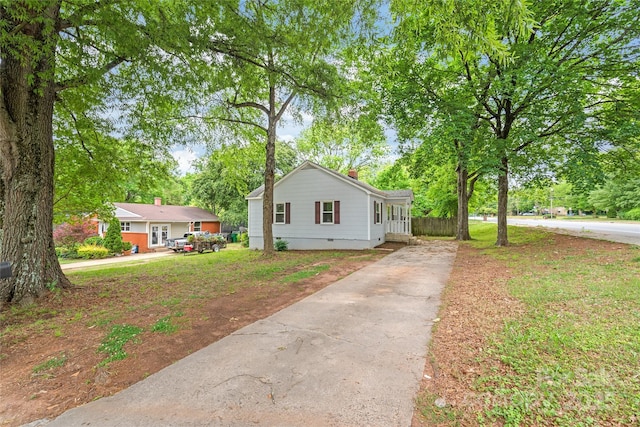 104 Willetta Dr, Charlotte, NC 28217 - view of front of house featuring driveway, a chimney, view of wooded area, and crawl space
