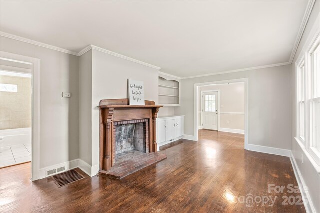 104 Willetta Dr, Charlotte, NC 28217 - unfurnished living room featuring wood finished floors, baseboards, ornamental molding, and a fireplace