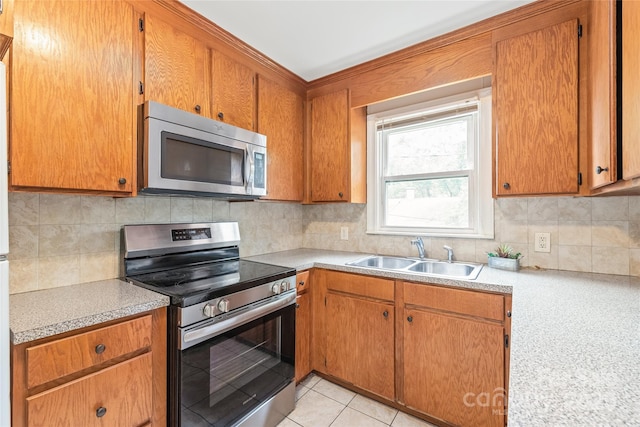 104 Willetta Dr, Charlotte, NC 28217 - kitchen featuring appliances with stainless steel finishes, a sink, light countertops, and tasteful backsplash