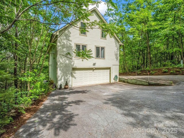 view of home's exterior with driveway and an attached garage
