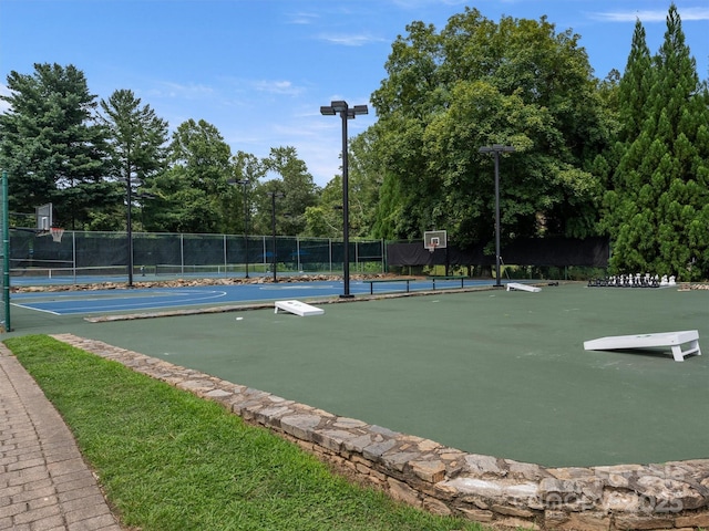 view of community featuring community basketball court and fence
