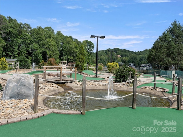view of property's community featuring a putting area