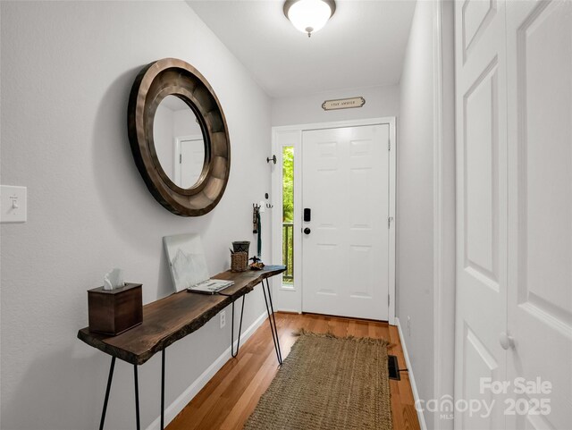 entryway with light wood-style floors and baseboards
