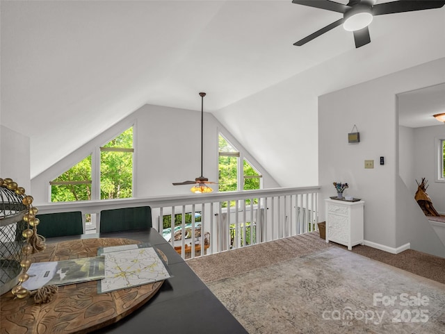 bonus room with ceiling fan, plenty of natural light, vaulted ceiling, carpet, and baseboards