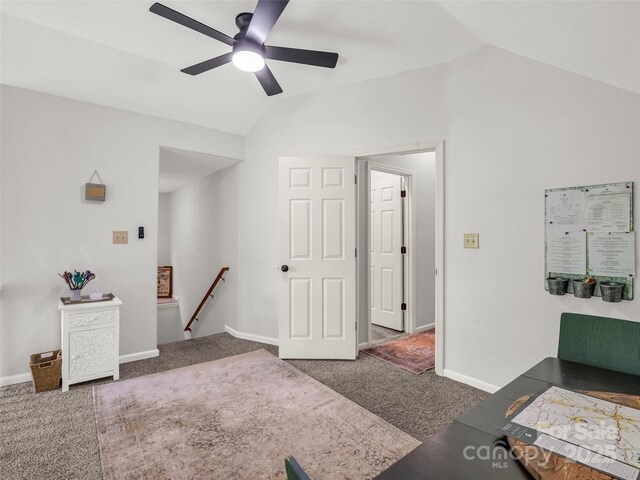 living area with lofted ceiling, a ceiling fan, carpet, and baseboards