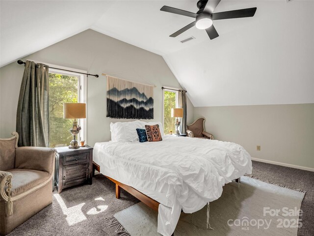 carpeted bedroom featuring multiple windows, vaulted ceiling, a ceiling fan, and baseboards