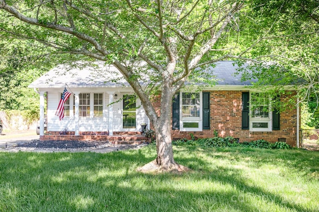 1115 Grovewood Dr, Charlotte, NC 28208 - view of front of house with a front lawn, brick siding, roof with shingles, and a porch