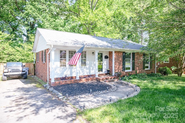 1115 Grovewood Dr, Charlotte, NC 28208 - ranch-style home featuring brick siding, a porch, and driveway