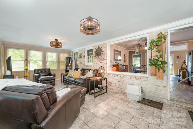 1115 Grovewood Dr, Charlotte, NC 28208 - living room featuring crown molding, brick wall, and a chandelier