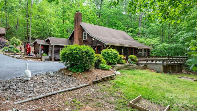 3763 Laurel Heights Dr, Morganton, NC 28655 - view of property exterior with log exterior, a chimney, a wooded view, and a deck