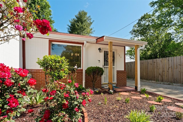 view of front of home with fence and brick siding