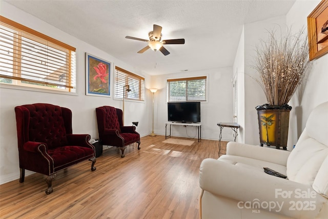 living room with ceiling fan and wood finished floors