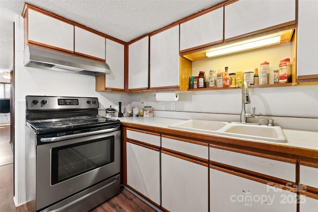 kitchen featuring stainless steel electric range, under cabinet range hood, a sink, white cabinetry, and light countertops