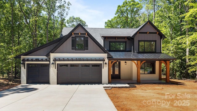 1408 Bloomsberry Ln, Waxhaw, NC 28173 - modern inspired farmhouse with a porch, driveway, a standing seam roof, and board and batten siding