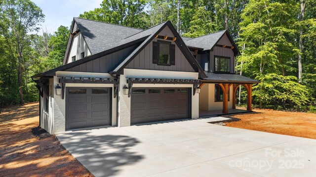 1408 Bloomsberry Ln, Waxhaw, NC 28173 - modern farmhouse with concrete driveway, board and batten siding, a garage, roof with shingles, and brick siding
