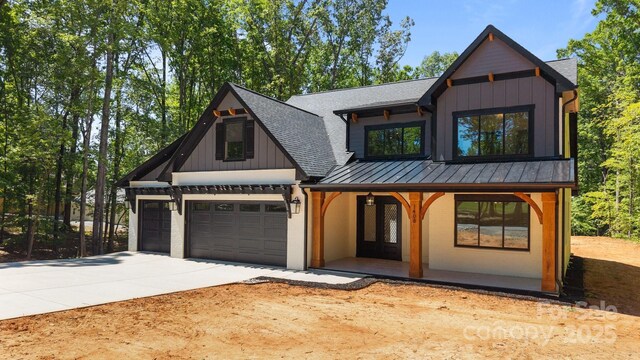 1408 Bloomsberry Ln, Waxhaw, NC 28173 - modern inspired farmhouse featuring a standing seam roof, a shingled roof, driveway, and board and batten siding