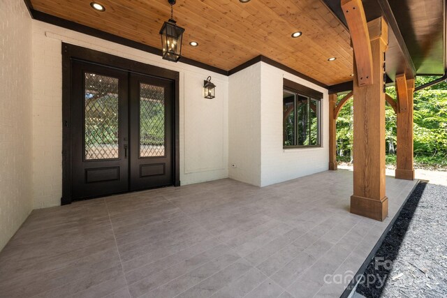 1408 Bloomsberry Ln, Waxhaw, NC 28173 - view of exterior entry with french doors, a patio, and brick siding