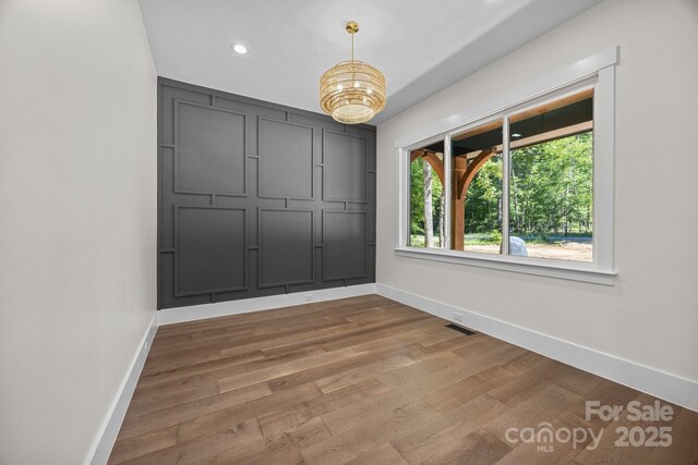 1408 Bloomsberry Ln, Waxhaw, NC 28173 - spare room featuring baseboards, wood finished floors, recessed lighting, and a chandelier