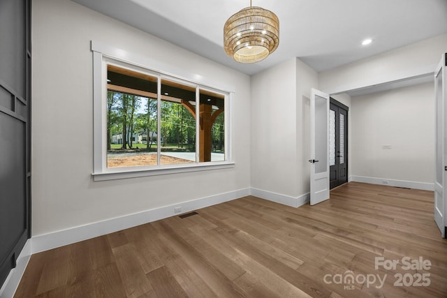 1408 Bloomsberry Ln, Waxhaw, NC 28173 - unfurnished room featuring a chandelier, baseboards, wood finished floors, and recessed lighting