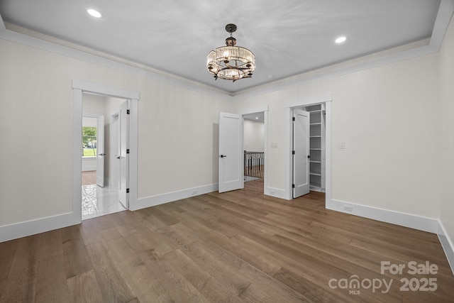 1408 Bloomsberry Ln, Waxhaw, NC 28173 - unfurnished bedroom featuring ornamental molding, a chandelier, baseboards, wood finished floors, and recessed lighting