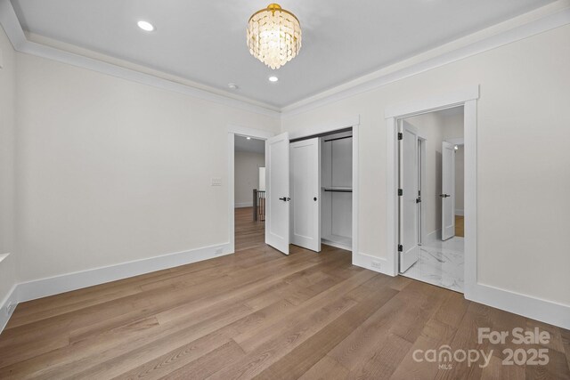 1408 Bloomsberry Ln, Waxhaw, NC 28173 - unfurnished bedroom with a chandelier, light wood-style flooring, recessed lighting, baseboards, and a closet