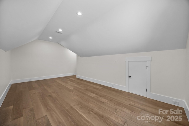 1408 Bloomsberry Ln, Waxhaw, NC 28173 - bonus room featuring lofted ceiling, baseboards, recessed lighting, and wood finished floors