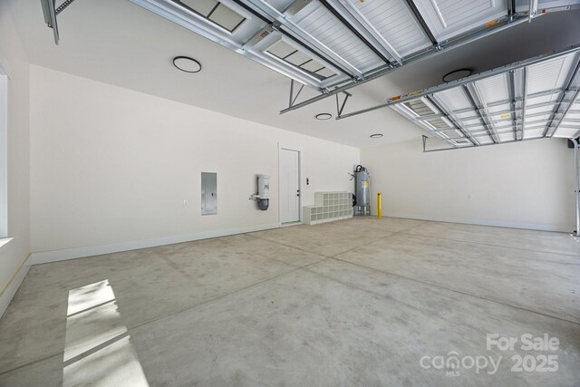 1408 Bloomsberry Ln, Waxhaw, NC 28173 - garage featuring electric water heater, electric panel, baseboards, and a central vacuum unit